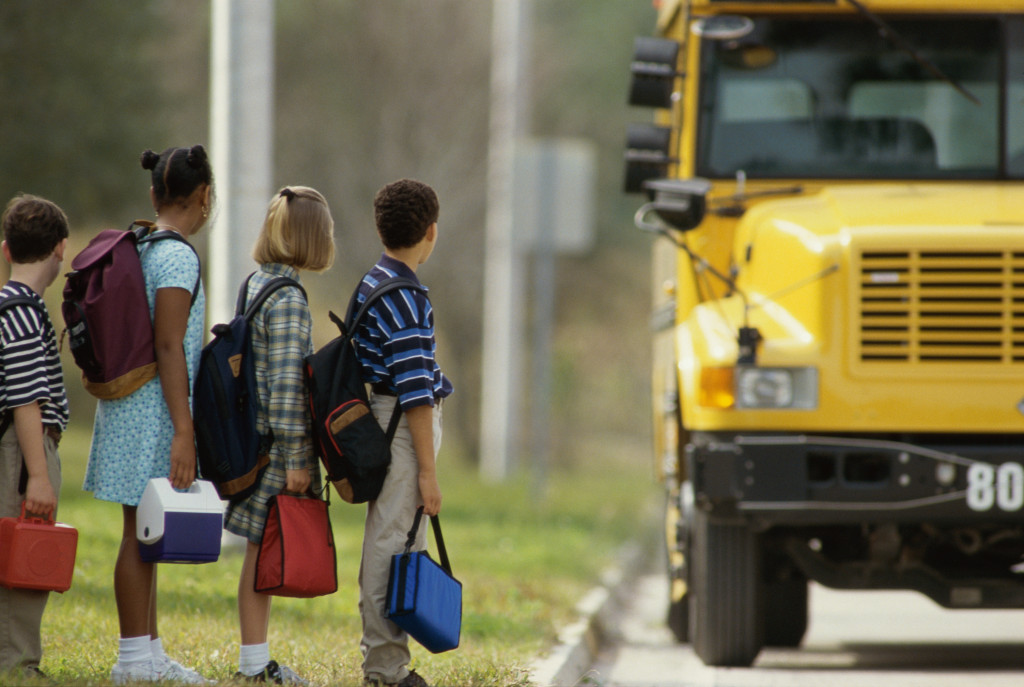 School children standing in line outside the schoo