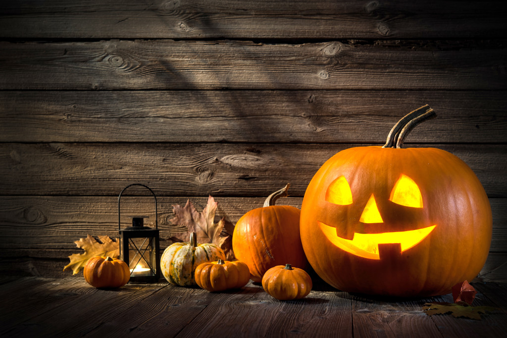 Halloween pumpkin head jack lantern on wooden background