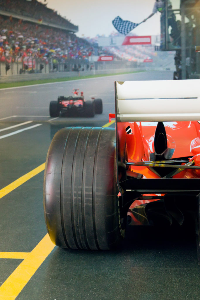 black tyre of red race car on the finish of race