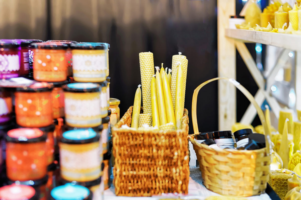 Stall with festive wax candles at the Street Christmas Market in Vilnius, Lithuania. The market is an annual tradition and a part of celebration. Selective focus