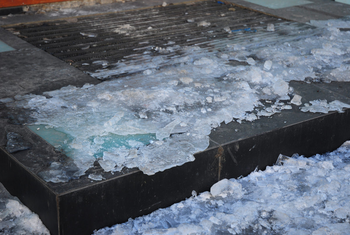 Close up on Danger Frozen Steps. Ice Covered Slippery Stair Case.