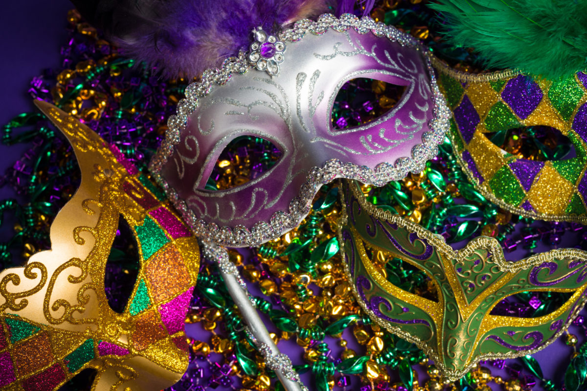 Festive Grouping of mardi gras, venetian or carnivale mask on a purple background