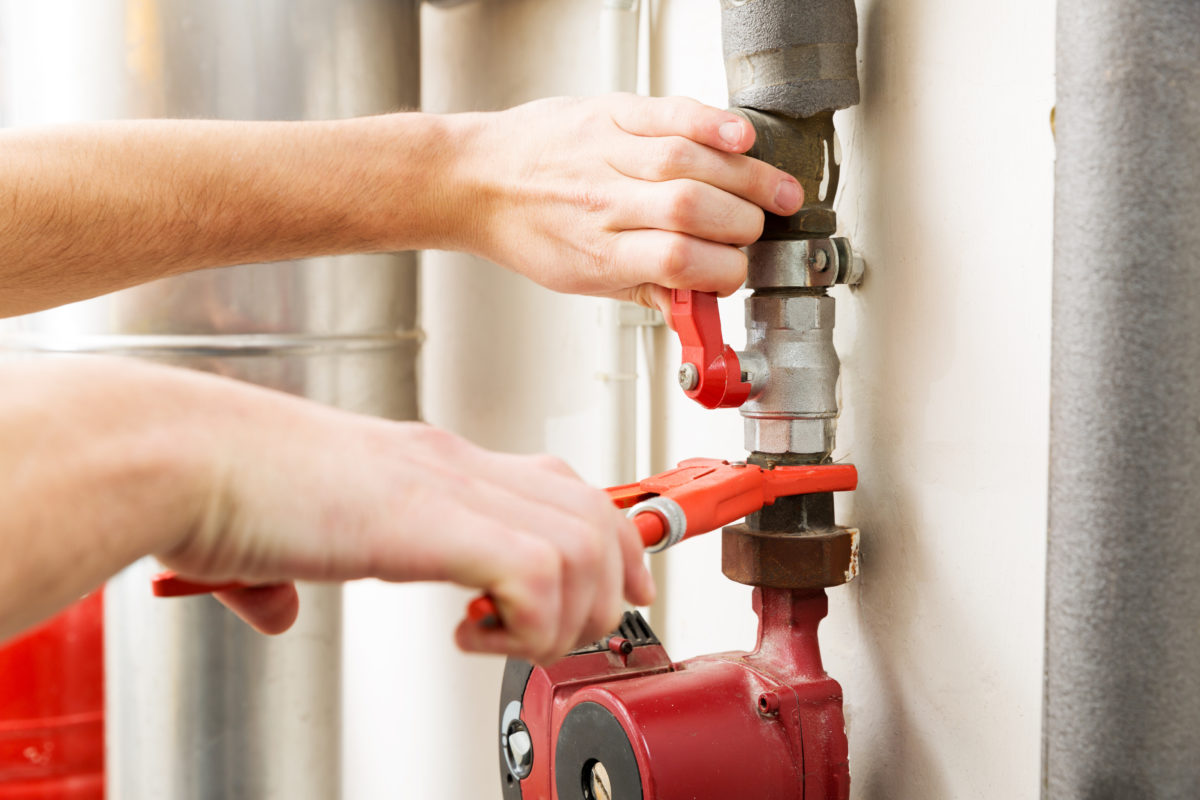 closeup of plumber hands working with pipeline connections