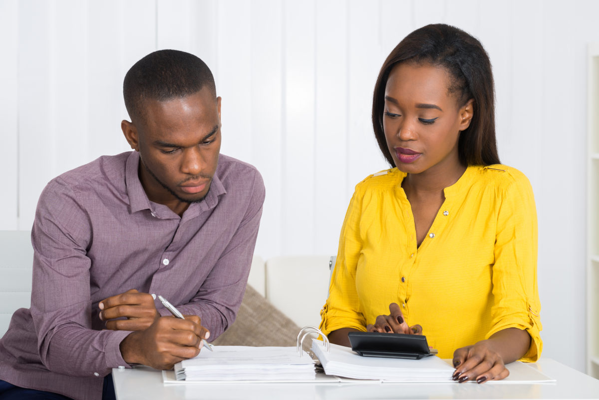 Photo Of Young Couple Calculating Bill At Home