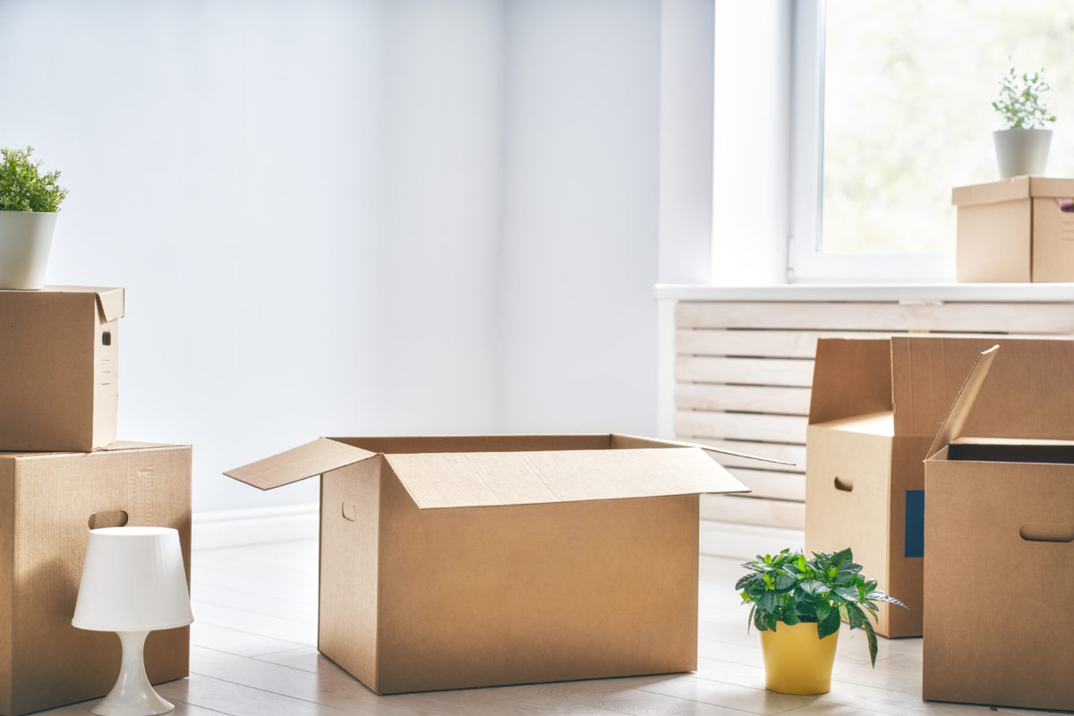 Cardboard boxes in empty new apartment.