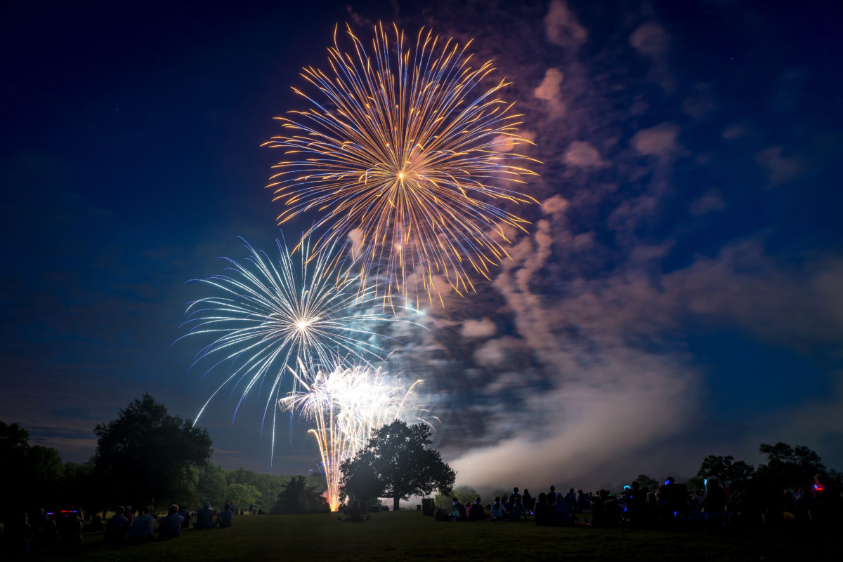 People looking at fireworks in honor of Independence Day