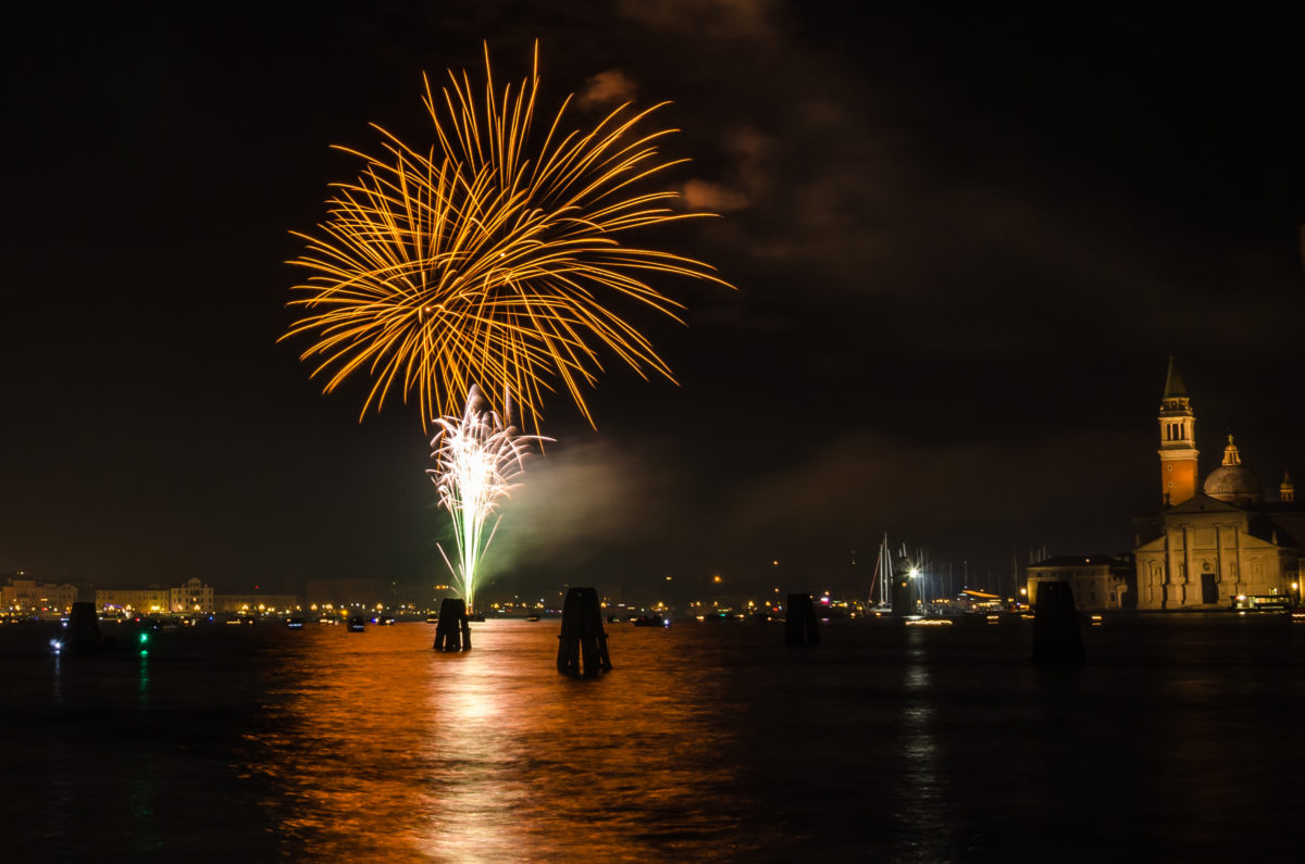 Beautiful Colourful Fireworks in Venice and Reflection in Water. St George Churchis visible on the right of the picture.