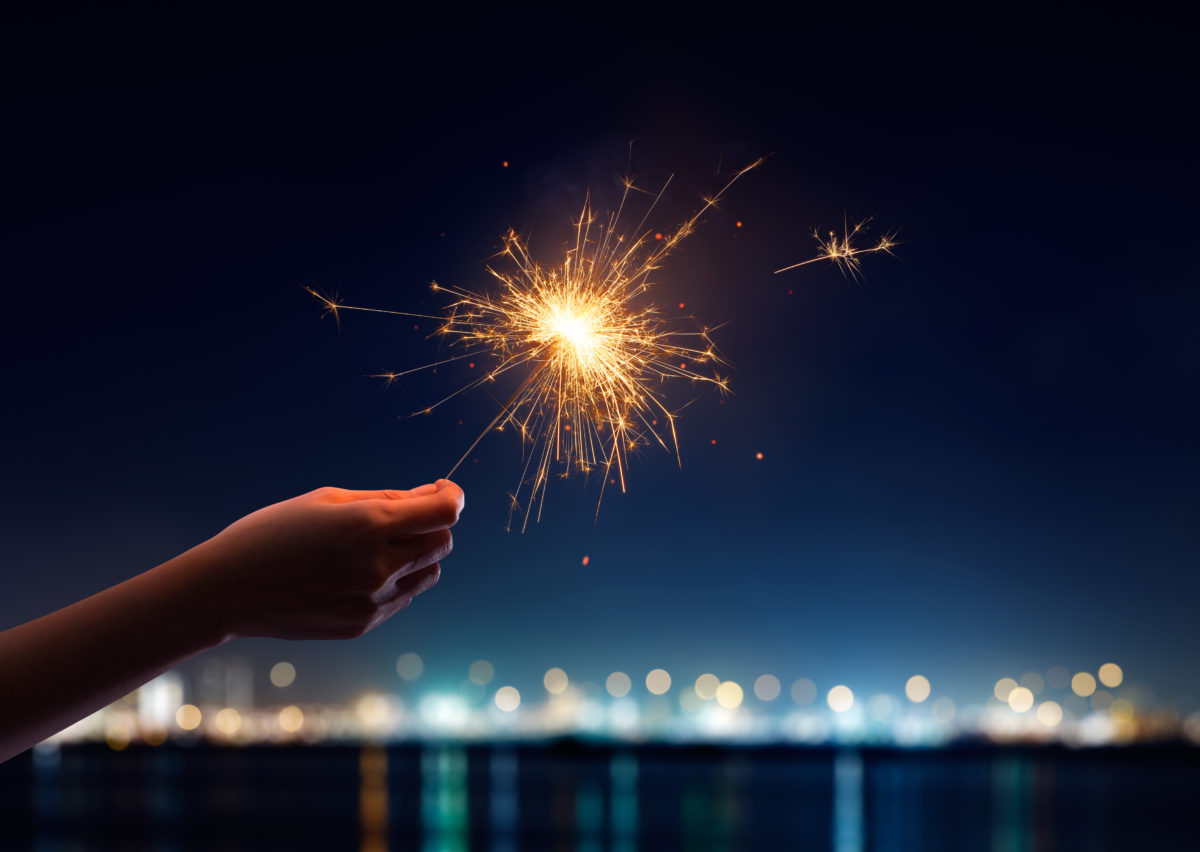 Female hand holding a burning sparkler