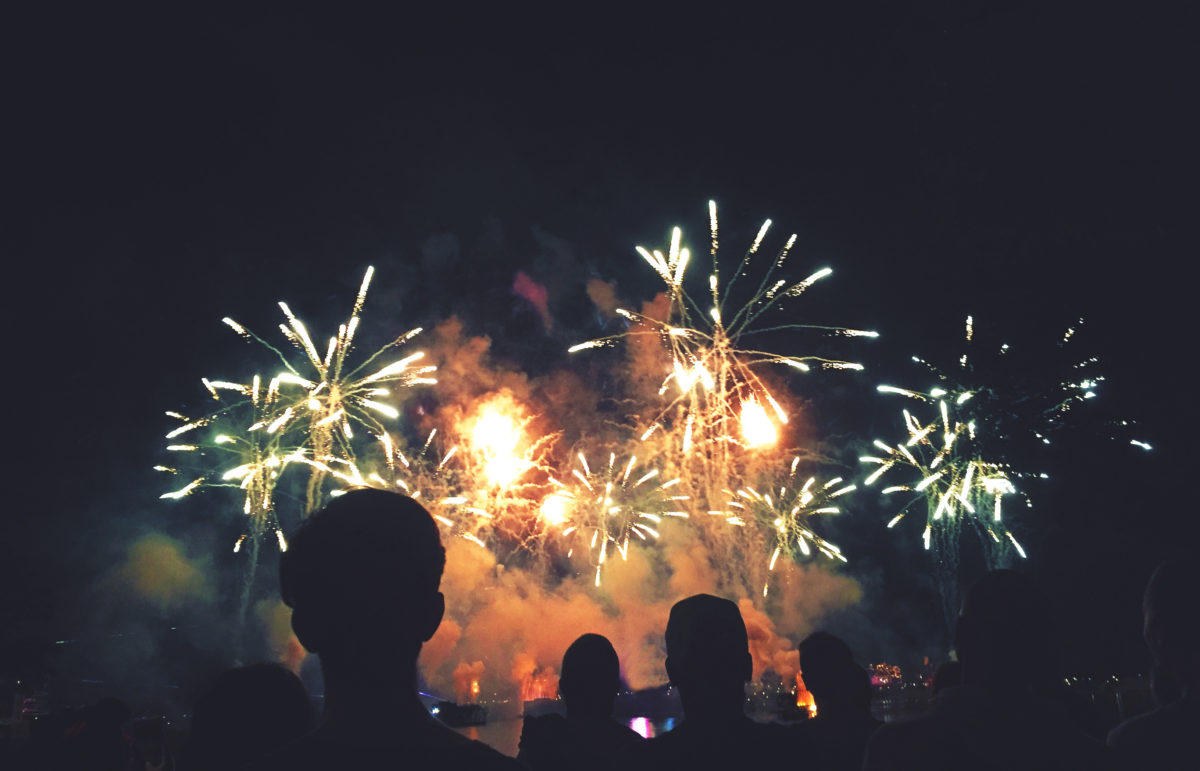 Crowd of Silhouetted People Watching a Colorful Fireworks Display for New Years or Fourth of July Celebration Event, Horizontal, Copy Space