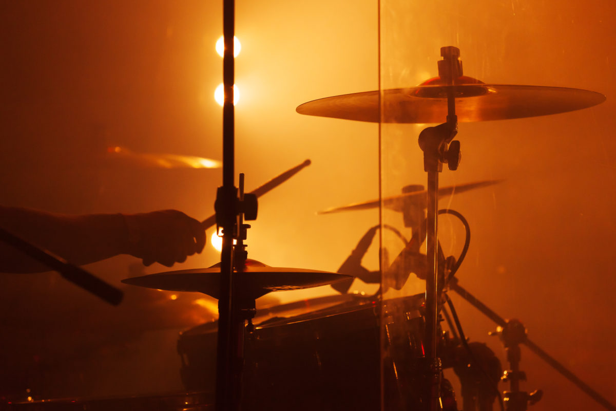 Live music background, drum set with cymbals and drummer hand