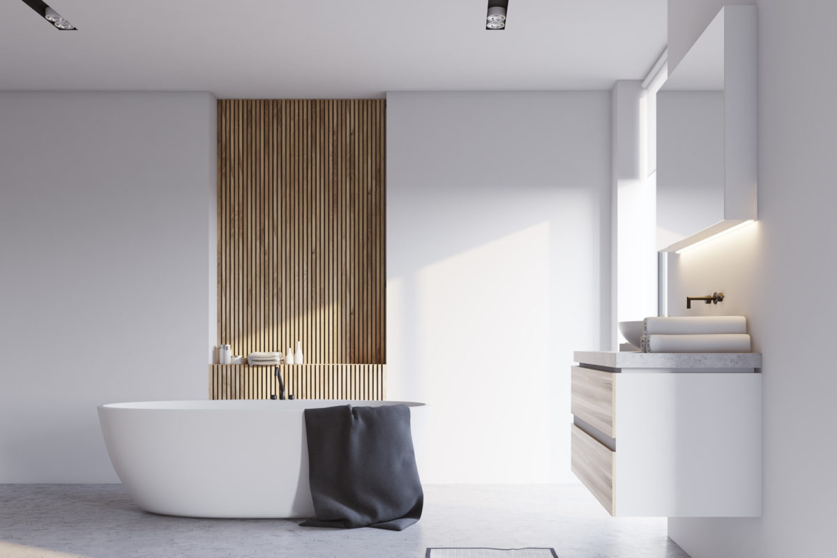 White and wooden bathroom interior with a concrete floor, a white bathtub and a sink with a big mirror hanging above it. 3d rendering mock up